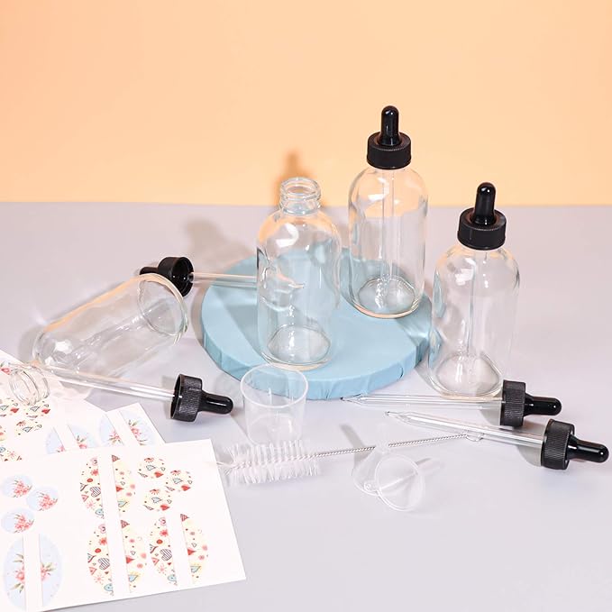 12 Pack 4oz Clear Glass Bottles with Glass Eye Droppers for Essential Oils, Perfumes & Lab Chemicals (1 Brush, 2 Funnels, 2 Extra Droppers, 24 Pieces Labels & 30ml Measuring Cup Included)